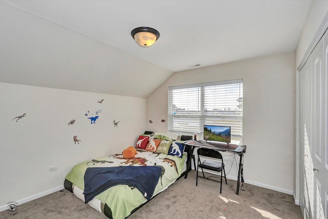 carpeted bedroom featuring vaulted ceiling, a closet, visible vents, and baseboards