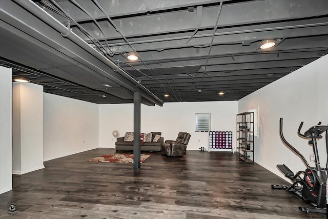 workout room featuring baseboards and wood finished floors