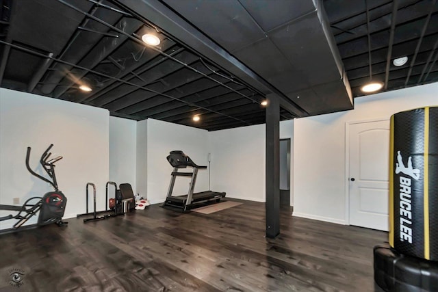 workout room with baseboards and wood finished floors