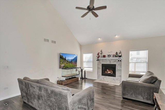 living room with visible vents, a fireplace, and wood finished floors