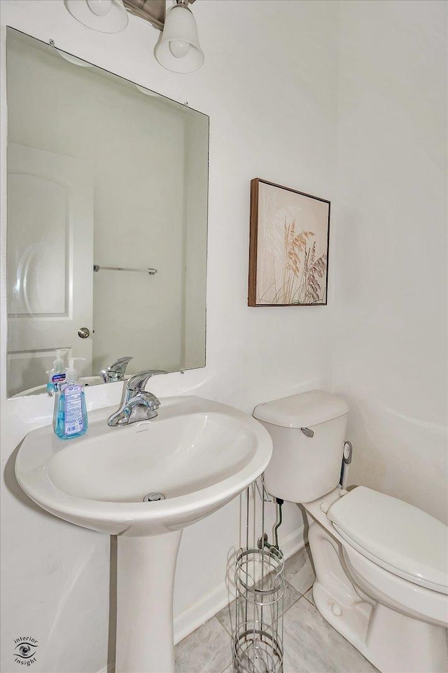 bathroom featuring tile patterned flooring and toilet