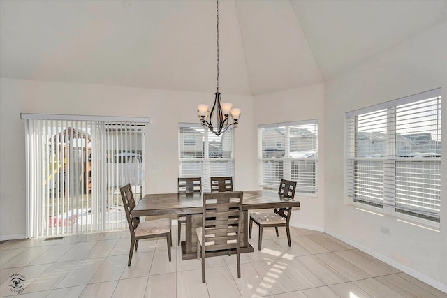 dining area with lofted ceiling, baseboards, a notable chandelier, and light tile patterned flooring