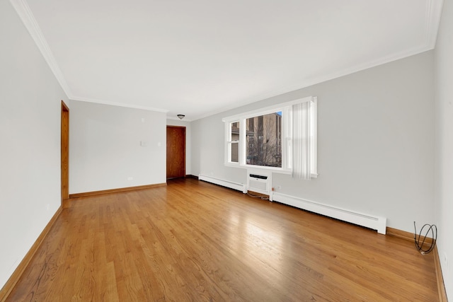 spare room with light hardwood / wood-style floors, ornamental molding, and a baseboard heating unit