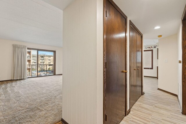 hallway featuring hardwood / wood-style floors and a textured ceiling