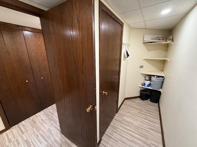 clothes washing area featuring washer and dryer and cabinets