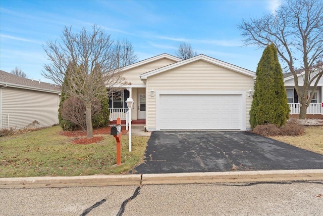 single story home with covered porch, a garage, and a front yard