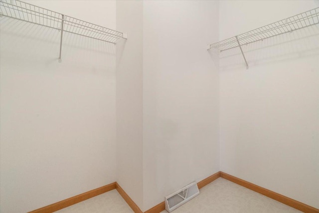 spacious closet featuring carpet floors