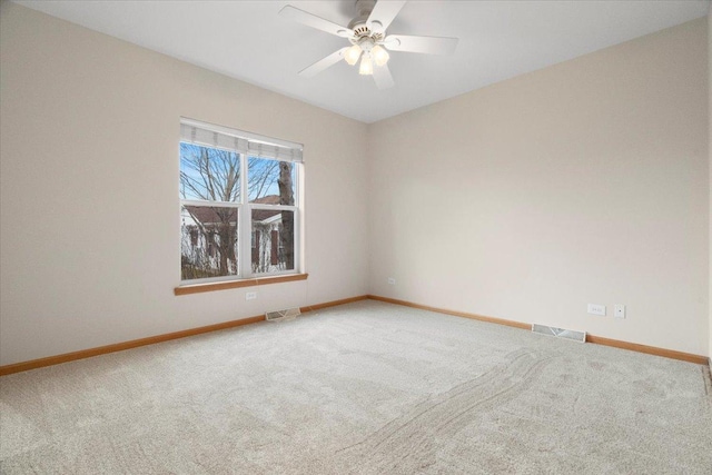 carpeted spare room with ceiling fan