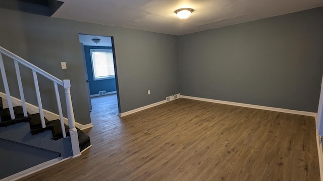 spare room featuring wood-type flooring