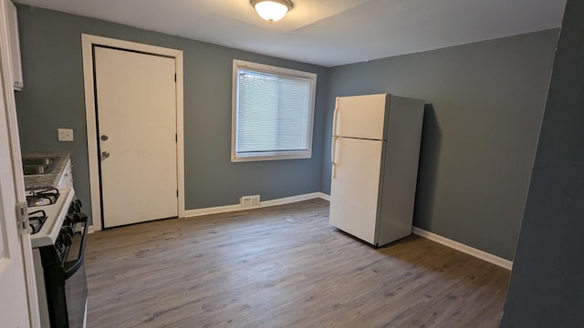 kitchen featuring white appliances and light wood-type flooring