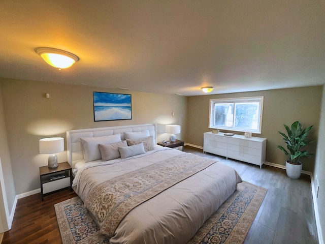 bedroom with dark hardwood / wood-style floors