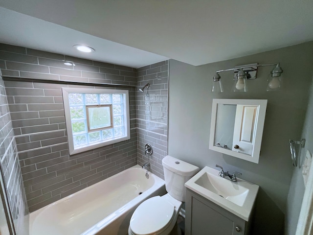 full bathroom with tiled shower / bath combo, toilet, and vanity