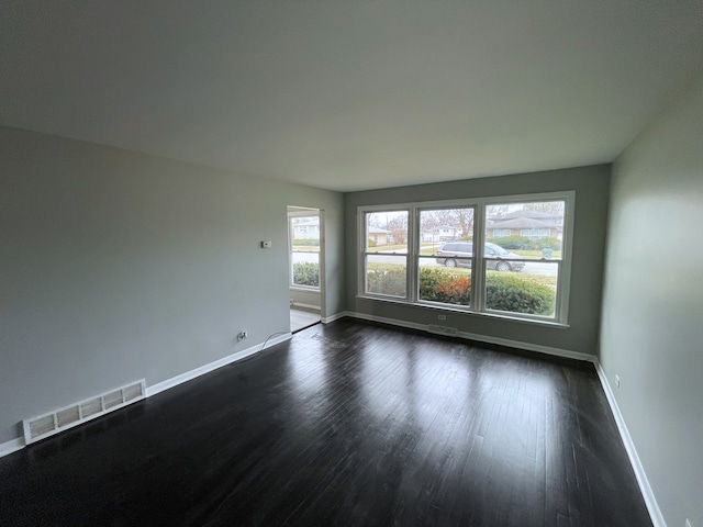 empty room featuring dark hardwood / wood-style flooring