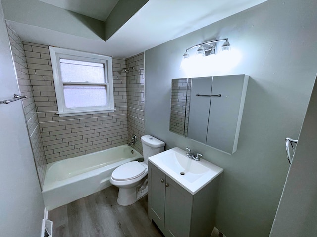 full bathroom with vanity, toilet, wood-type flooring, and tiled shower / bath