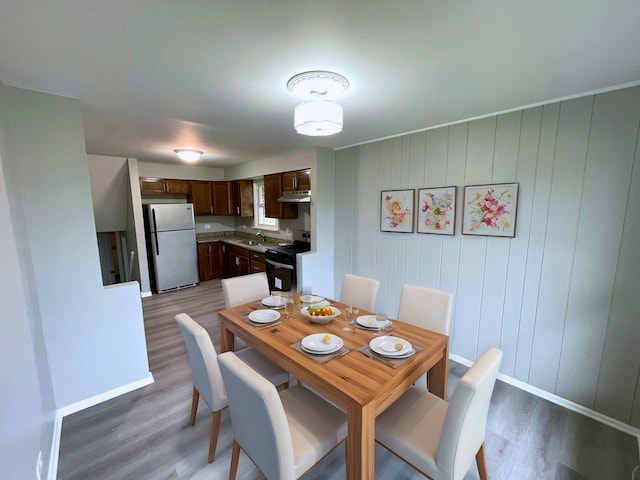 dining room featuring wood-type flooring and sink