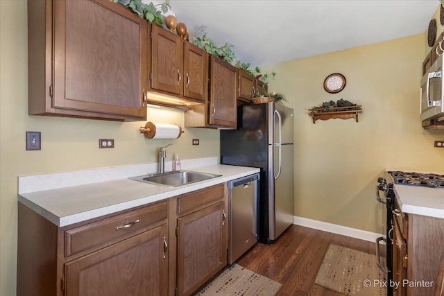 kitchen featuring sink, dark hardwood / wood-style floors, and appliances with stainless steel finishes