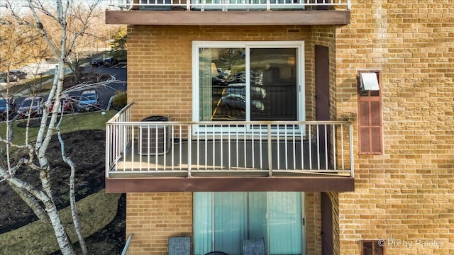 view of side of home featuring a balcony and cooling unit