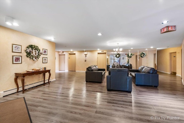 living room featuring a chandelier, dark hardwood / wood-style flooring, and a baseboard radiator