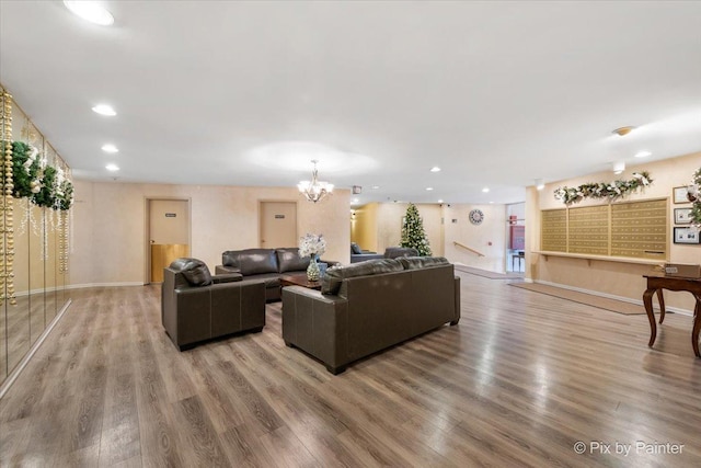 living room featuring a chandelier and wood-type flooring