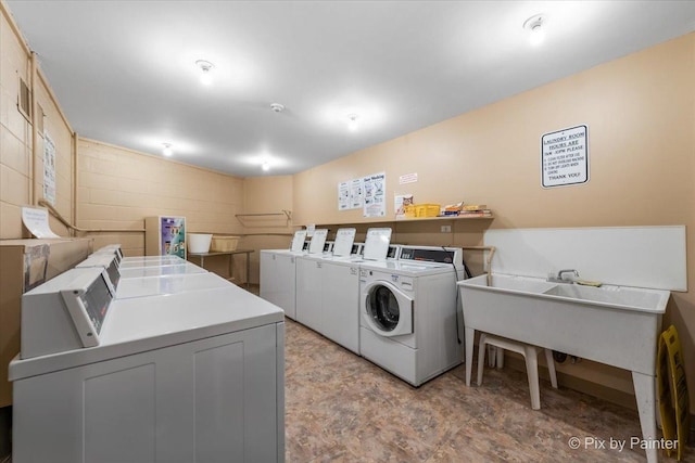 washroom with separate washer and dryer and sink