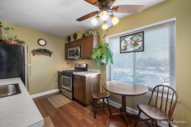 kitchen featuring sink, stainless steel appliances, dark hardwood / wood-style floors, and ceiling fan