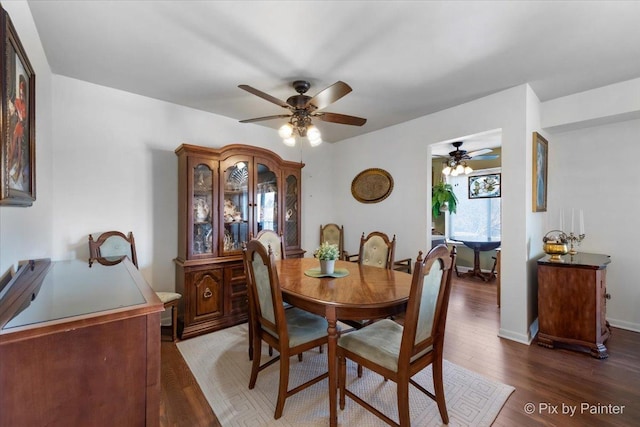 dining area featuring dark hardwood / wood-style flooring and ceiling fan