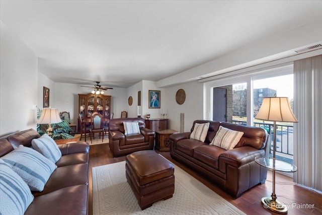 living room featuring hardwood / wood-style floors and ceiling fan