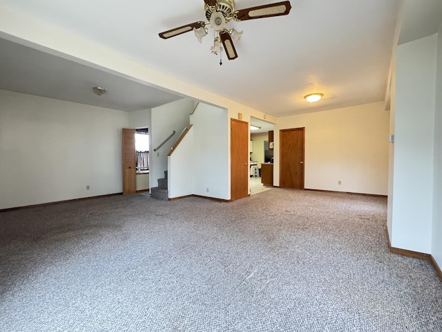 unfurnished living room featuring carpet flooring and ceiling fan