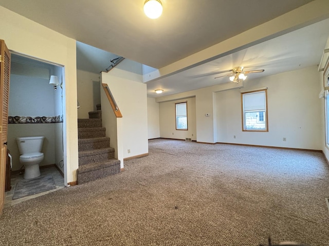 unfurnished living room featuring ceiling fan and carpet floors