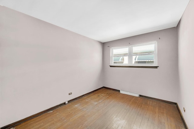 empty room featuring visible vents, baseboards, and light wood-style floors