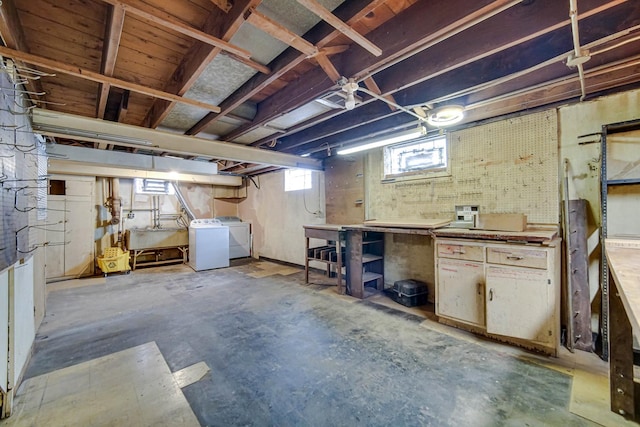 below grade area featuring a workshop area, independent washer and dryer, and a sink