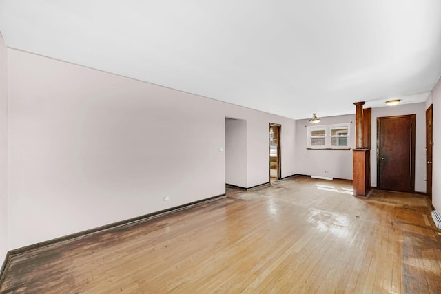 unfurnished living room featuring light wood-style flooring and baseboards