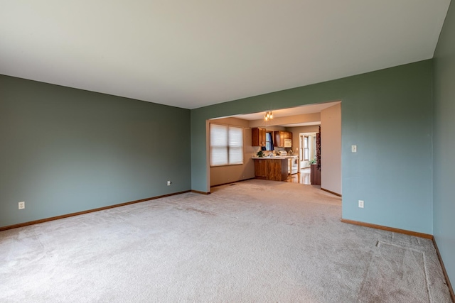 unfurnished living room with light colored carpet