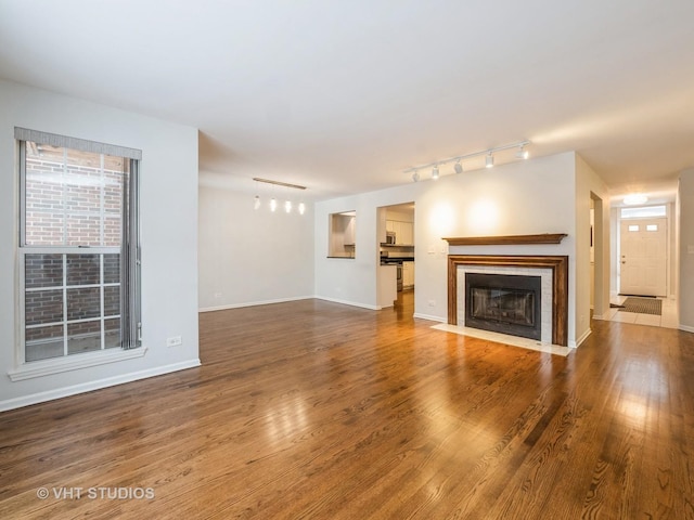 unfurnished living room with dark hardwood / wood-style flooring