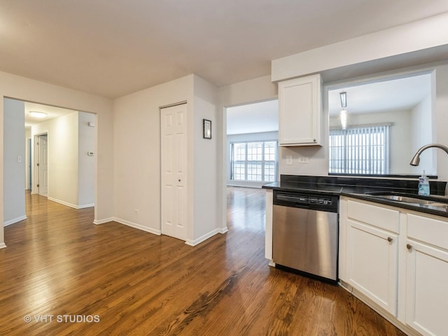 kitchen featuring stainless steel dishwasher, white cabinets, sink, and dark wood-type flooring