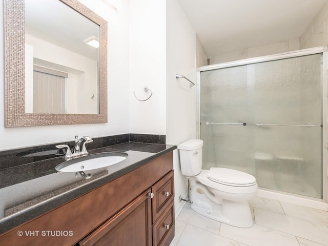 bathroom with walk in shower, vanity, and toilet