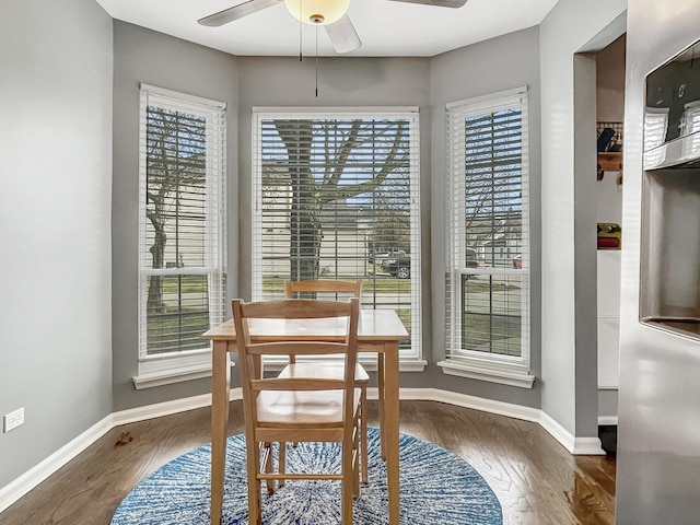 dining area featuring ceiling fan and dark wood-type flooring