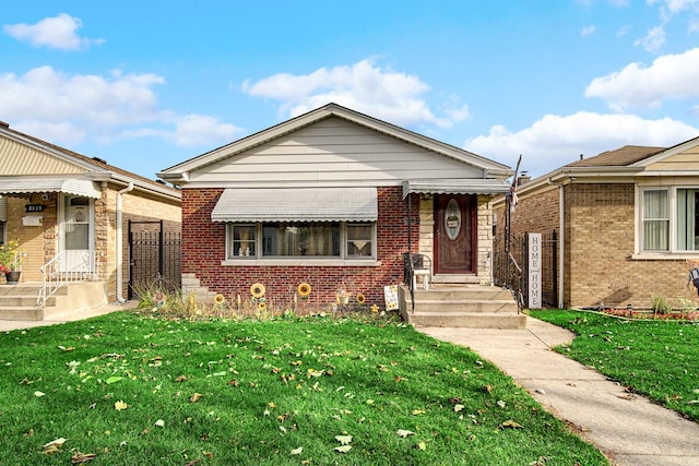 bungalow-style home with a front lawn