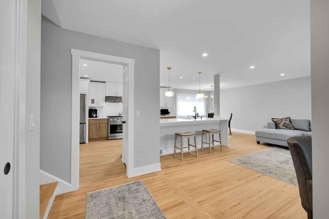 interior space with sink and light hardwood / wood-style flooring