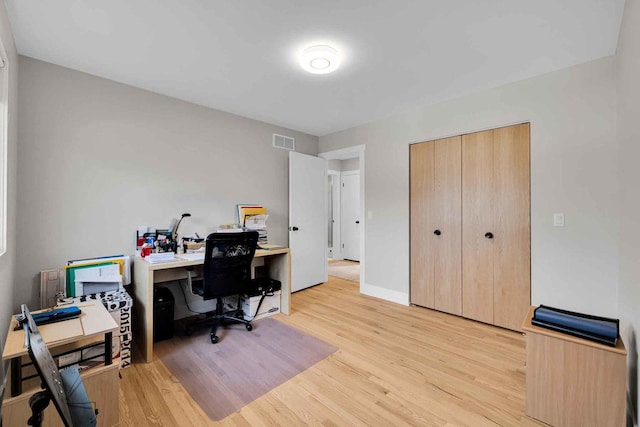 office with light wood-type flooring