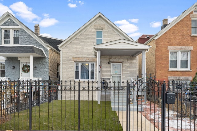 view of front of home featuring stone siding, a fenced front yard, and a front yard