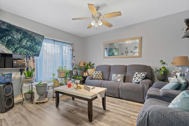 living room with washer / clothes dryer, ceiling fan, and wood finished floors