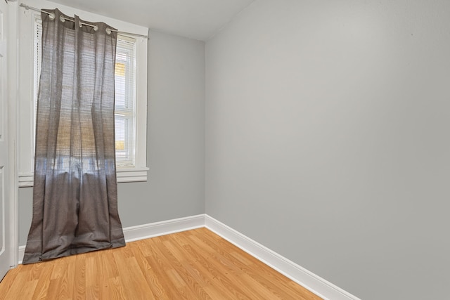 spare room with light wood finished floors and baseboards