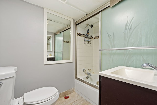 full bathroom featuring toilet, baseboards, combined bath / shower with glass door, and vanity