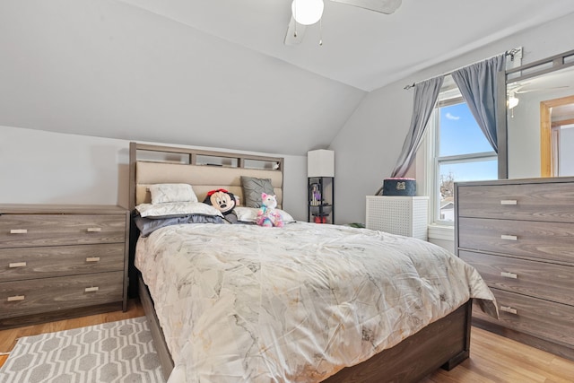 bedroom with light wood-type flooring, ceiling fan, and lofted ceiling