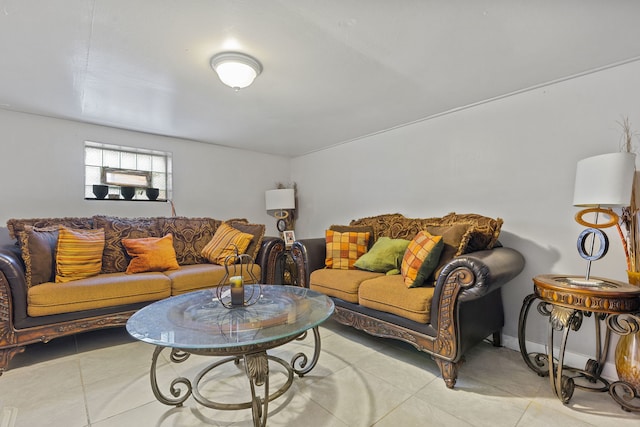 living area with light tile patterned floors and baseboards