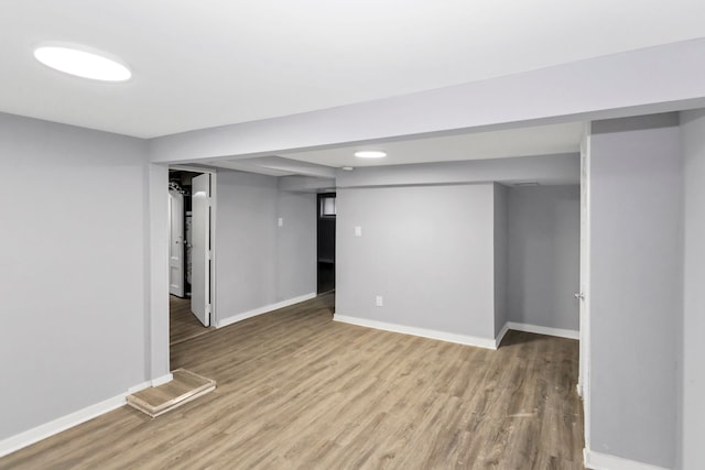 finished basement featuring baseboards and wood finished floors