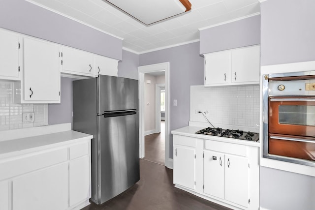 kitchen with freestanding refrigerator, ornamental molding, wall oven, light countertops, and a warming drawer