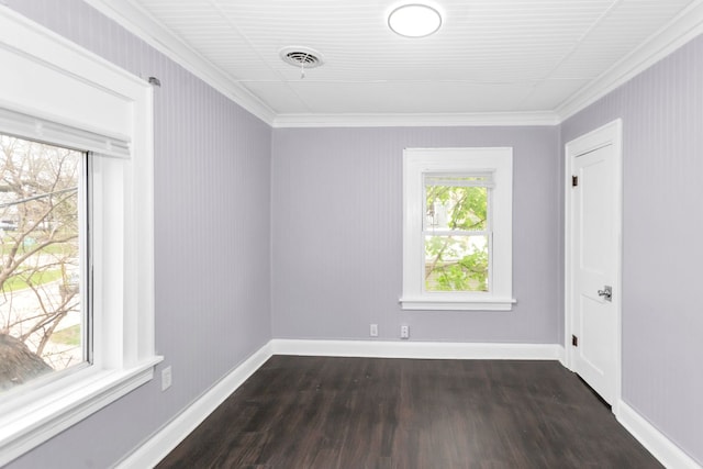 unfurnished room featuring visible vents, ornamental molding, baseboards, and dark wood-style floors