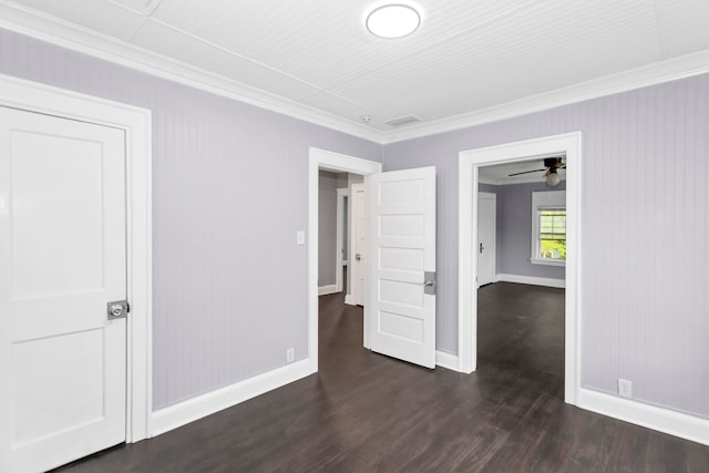 unfurnished bedroom with baseboards, dark wood finished floors, and ornamental molding